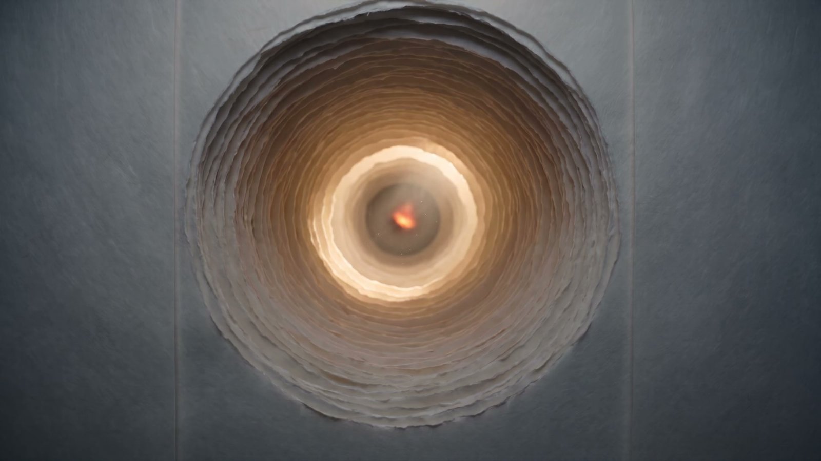 Warm light glowing through layers of torn paper